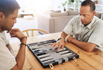 Man, senior and play backgammon in house with focus, strategy and contest for thinking, moving or...