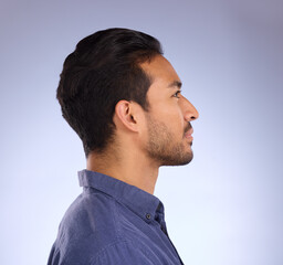 Fototapeta premium Profile, head and thinking with a man in studio on a gray background looking thoughtful or contemplative. Idea, side and face with a handsome young male contemplating a thought on a color wall