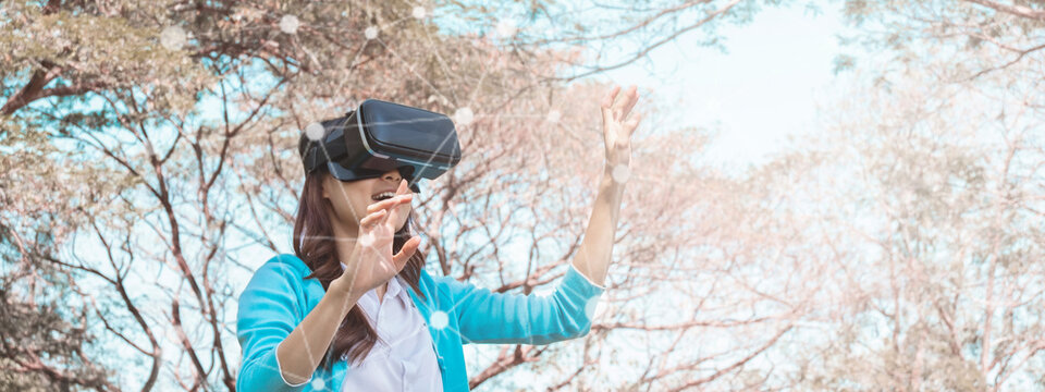 Young asian girl using vr headset for relax. For banner design. - Powered by Adobe