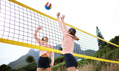 Volleyball, beach and spike with sports women playing a game outdoor for training or competition....