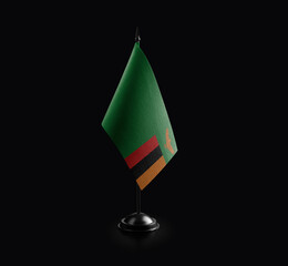 Small national flag of the Zambia on a black background