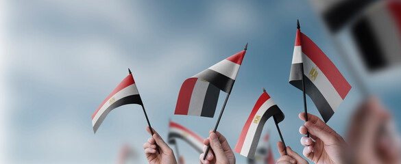 A group of people holding small flags of the Egypt in their hands