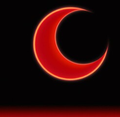 Scarlet crescent moon on black background