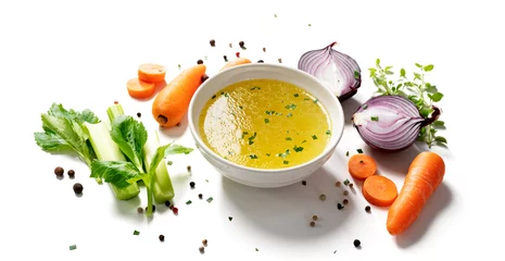 Foto op Plexiglas Chicken broth, stock or bouillon with vegetables isolated on white background © Nelea Reazanteva