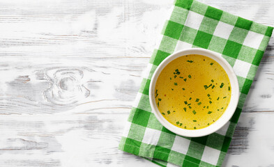 Chicken broth, stock or bouillon with vegetables, top view