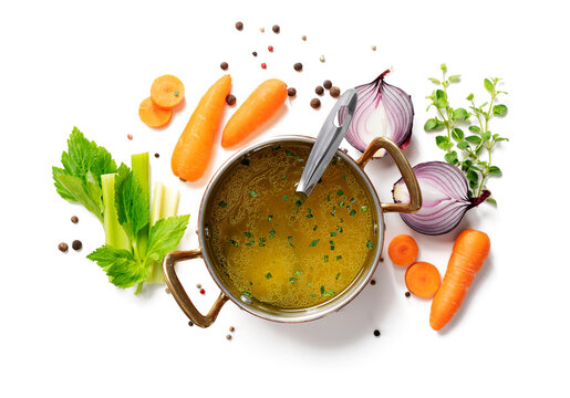 Chicken broth, stock or bouillon with vegetables isolated on white background, top view