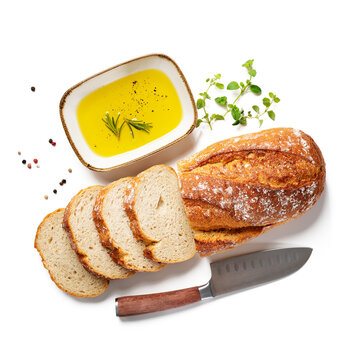Fresh bread slices with olive oil isolated on white background, top view