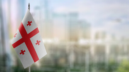 Small flags of the Georgia on an abstract blurry background