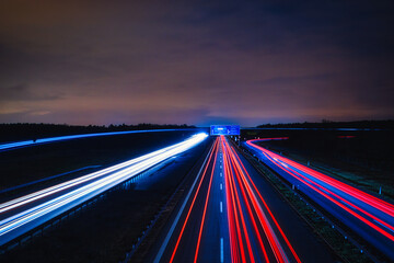 Fototapeta na wymiar Speed Traffic - Highway at Night - Cars - Nachtverkehr auf Autobahn - Light Trails - Datenautobahn - Speeding - German - Ecology - Long Exposure - Light Trails - High quality photo 