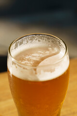 A glass of beer on the table of a beer bar. Amber Lager alcoholic drink.