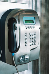 Payphone on the wall. Modern payphone for paid calls in a public place.