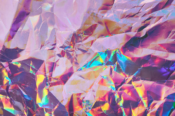 Iridescent holographic textural Background. Wrinkled folded paper or foil with iridescent highlights