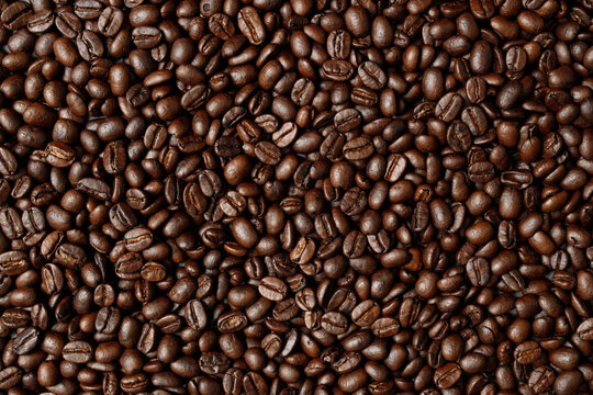 photo macro close up texture of roasted coffee beans dark, can be used as a background.