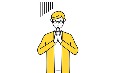 体の前で手を合わせて謝るカジュアルな格好をした若い男性