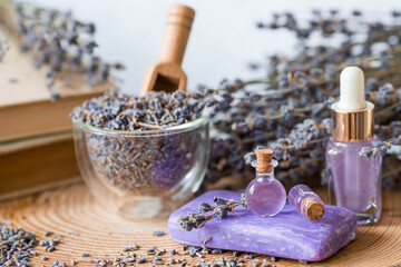 Aromatherapy. Massage and spa. Cosmetic bottles of lavender essential oil, old books, dried flowers...