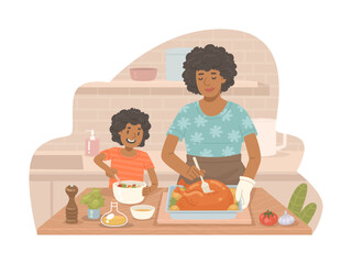 Beautiful African American woman cooks a turkey with her daughter who prepares a salad