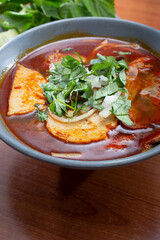 A view of a bowl of bun bo hue.