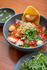 A view of a bowl of dry pork and shrimp noodle Soup, also known as Hu tieu kho voi nuoc sot.