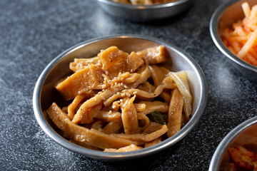 A view of a banchan bowl of stir-fried fishcake.