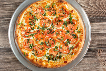 A top down view of a rustic Margherita pizza pie.