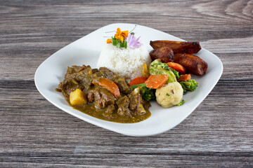 A view of a plate of coconut goat curry.