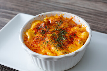 A view of a ramekin bowl of macaroni and cheese dish.