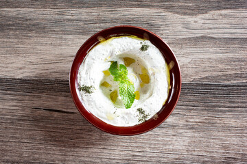 A top down view of a bowl of tzatziki.