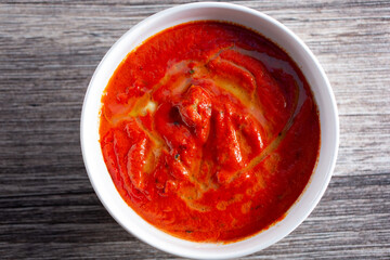 A top down view of a bowl of chicken tikka masala.