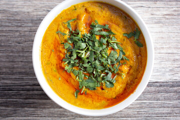 A top down view of a bowl of chicken korma.