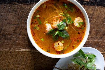 A top down view of a bowl of seafood pho.