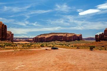 Car on a road trip in the desert in Monument Valley in the USA