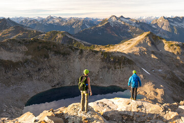 Two backpackers above alpine tarn, Douglas Peak, British Columbia.