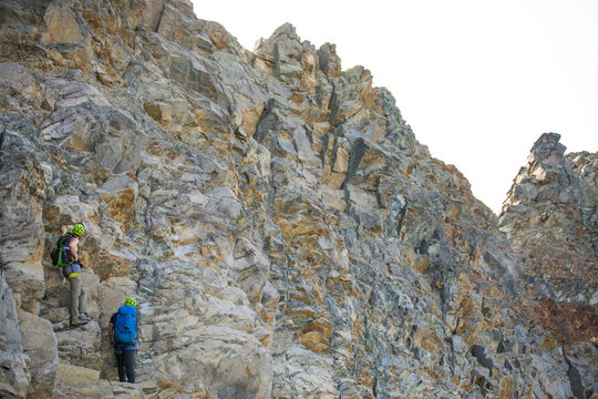 Climbers routefinding on headwall of Douglas Peak, British Columbia.