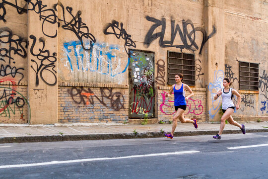 Female runners training in industrial area of Brooklyn
