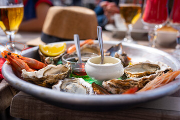 Closeup of oysters and seafood on french terrace.