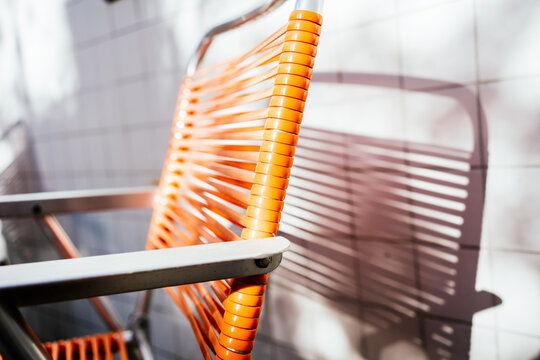 Vintage Orange Chair With Shadow Reflected On The Wall