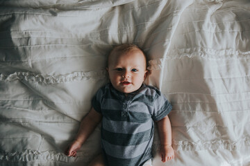 Portrait of baby boy in striped onesie