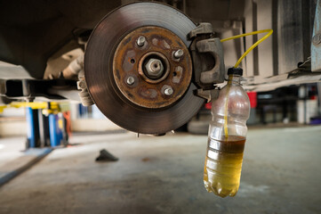 Automatic change of brake fluid in a car service. 