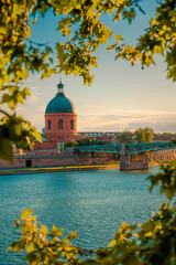 Toulouse, France. Beautiful cityscape with The River Garonne and La Grave dome in the background at sunset - obrazy, fototapety, plakaty