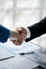 Close-up two business men shake hands, Two businessmen are agreeing on business together and...