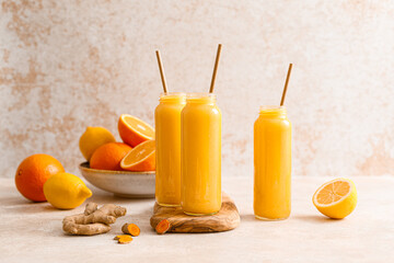 Smoothie. Healthy fresh raw detox citrus smoothie with orange, lemon, ginger and turmeric in a...