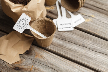 Empty biodegradable peat pot on wooden table. Preparation for planting seeds in spring