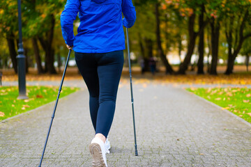 Nordic walking - woman training in city park
