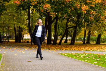 Beautiful woman walking in city park
