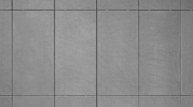dark gray cast stone texture as wall or floor material. refined architectural concrete building unit manufactured to simulate natural cut stone