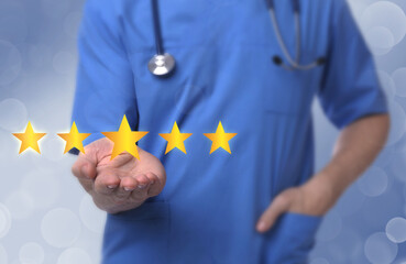 Quality evaluation. Doctor showing virtual golden stars on light blue background, closeup