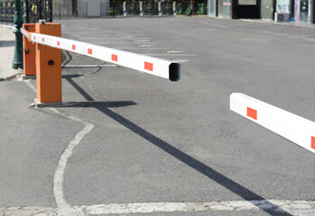 Closed boom barriers outdoors on sunny day