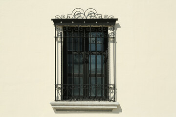 Beautiful window with grills on building, view from outdoors