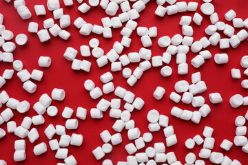 Delicious marshmallows on red background, flat lay