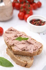 Fototapeta na wymiar Delicious liverwurst sandwich with basil on white table